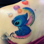 Stitch Character Inspired Tattoo With Vivd Watercolors And Calligraphy On The Shoulder Blade Tatuaje Stitch Inspirado Con Acuarelas Y Caligrafia En La Escapula <br>