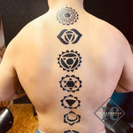 Chakra Tattoo On The Back With Big Bold Symbols In Black Tatuaje De Chakra En La Parte Posterior Con Grandes Símbolos En Negrita En Negro<br>