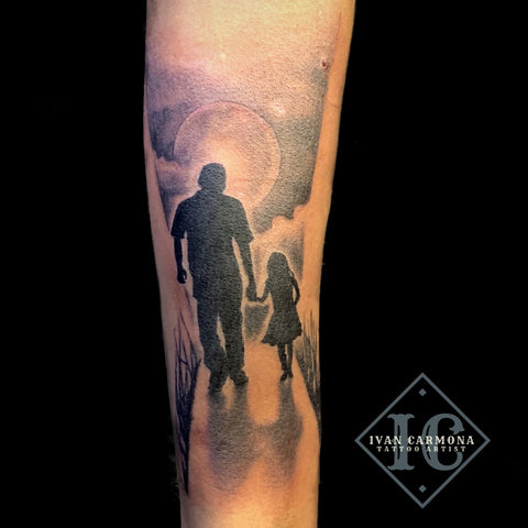 Father Daughter Silhouette Tattoo On The Forearm With Clouds And The Moon In Black And Gray Tatuaje De Silueta De Padre E Hija En El Antebrazo Con Nubes Y La Luna En Negro Y Gris<br>